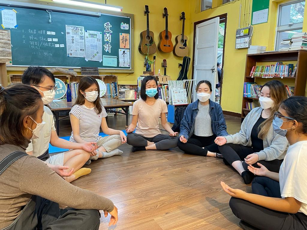 people meditating on their yoga mats in a open place